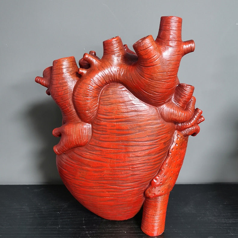 Close-up of red heart-shaped resin planter indoor vase showing detailed texture