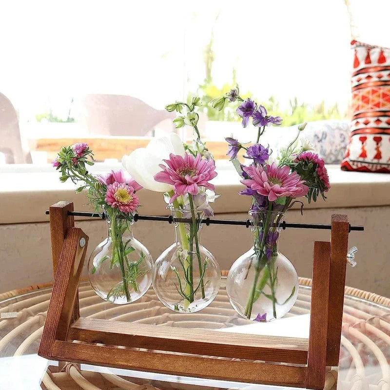 Triple glass tube hydroponic vase in wooden frame filled with flowers