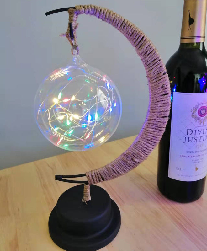 Moon-shaped glass night light with globe illuminated in multicolor LED lights