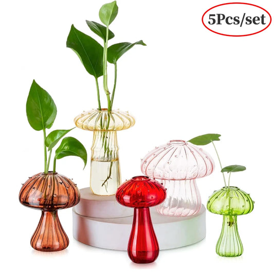 Mushroom shaped glass vases in multiple colors with green plants displayed for home décor
