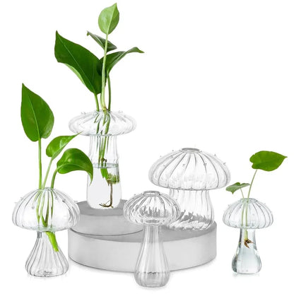 Set of five clear mushroom shaped glass vases displayed on table for floral decoration
