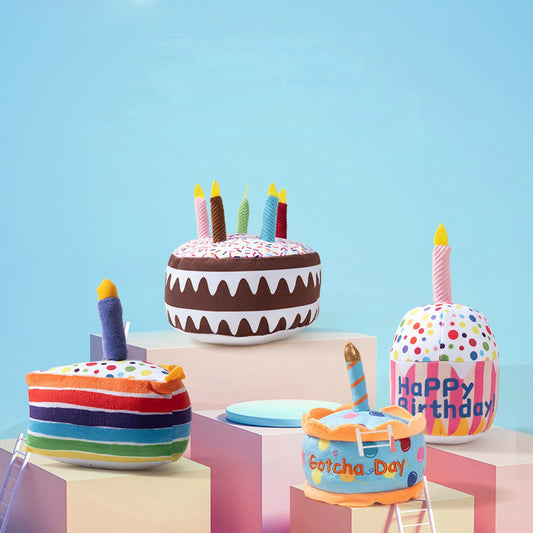 Plush pet birthday cake toys in multiple colorful designs displayed together
