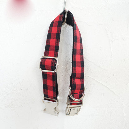 Red and black grid adjustable dog collar with metal buckle, shown hanging