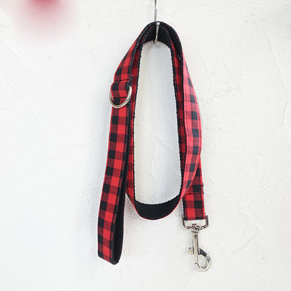 Red and black grid dog leash shown hanging to display full length