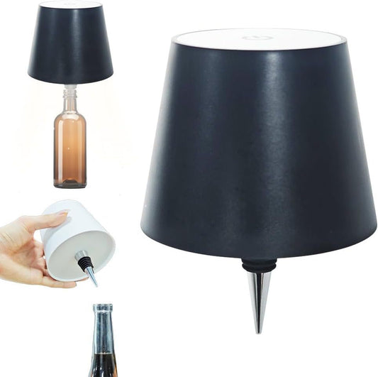 Black wine bottle cap desk lamp with plastic lamp holder placed on top of a brown glass bottle