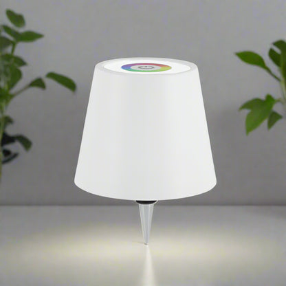 White outdoor lamp with a colorful light bulb on a gray background