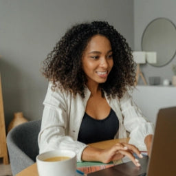 Woman using a laptop in a home office setting